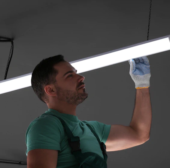 worker installing indoor lighting